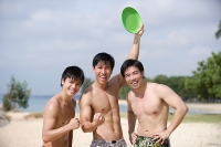 Three men on beach, smiling at camera - Asia Images Group