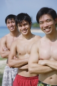Three men with arms crossed, in a row - Asia Images Group