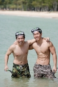 Two men standing in sea, arms around each other - Asia Images Group