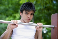 Young man doing chin-ups - Asia Images Group