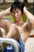 Man doing sit-ups outdoors - Asia Images Group