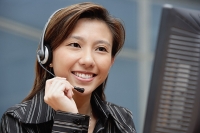 Female executive with hands free device - Asia Images Group