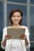 Female executive holding folders towards camera - Asia Images Group