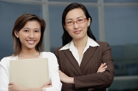 Two businesswomen standing side by side - Asia Images Group