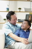 Father and son smiling each other - Asia Images Group