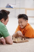Father and son playing chess - Asia Images Group