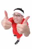 Man in soccer uniform making thumbs up sign - Asia Images Group