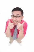 Man making thumbs up sign, smiling at camera - Asia Images Group