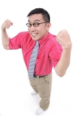 Man flexing his arms, smiling at camera - Asia Images Group