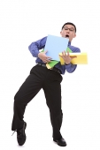 Clumsy businessman carrying folders - Asia Images Group
