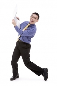 Businessman carrying laptop, smiling at camera - Asia Images Group