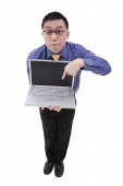 Businessman pointing at laptop - Asia Images Group