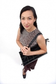 Woman with shoulder bag, looking at camera - Asia Images Group