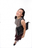Woman with shoulder bag, looking up - Asia Images Group