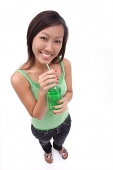 Young woman drinking from bottle - Asia Images Group