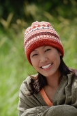 Woman with ski cap, wrapped in a blanket - Asia Images Group