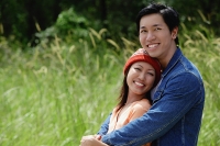 Couple embracing, smiling at camera, portrait - Asia Images Group