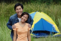 Couple with tent in the background, portrait - Asia Images Group