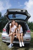 Women sitting in boot of car - Asia Images Group