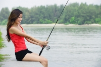 Woman with fishing rod - Asia Images Group