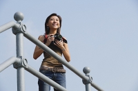 Woman holding camera - Asia Images Group