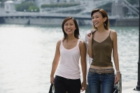 Two women walking side by side - Asia Images Group