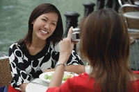Woman taking a picture of another woman - Asia Images Group