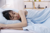 Young woman sleeping in bed - Asia Images Group