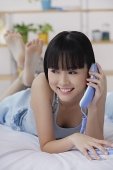 Young woman using telephone - Asia Images Group