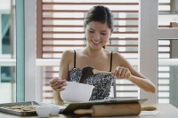 Young woman in kitchen holding mixing bowl - Asia Images Group