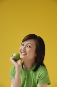 Young Woman holding apple - Asia Images Group