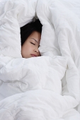 Young woman covered by blanket, sleeping - Asia Images Group