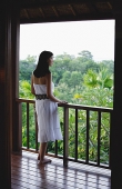 Young woman standing on balcony - Asia Images Group
