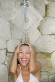 Young woman under shower, smiling - Asia Images Group