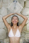 Young woman in white bikini, taking a shower - Asia Images Group