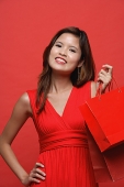 Woman in red dress with shopping bags - Asia Images Group