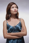 Woman in blue top, arms crossed, making a face - Asia Images Group