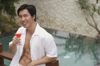 Man with cocktail in hand, portrait - Asia Images Group