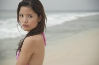 Woman standing on beach, looking at camera - Asia Images Group