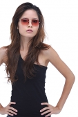 Young woman wearing sunglasses, hands on hips - Asia Images Group