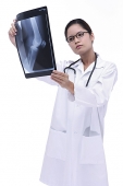 Doctor looking at  X-ray - Asia Images Group