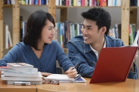 Couple studying together in library - Asia Images Group