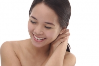 Young woman with eyes closed, smiling - Asia Images Group