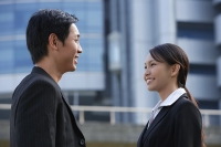 Businesswoman and businessman talking - Asia Images Group