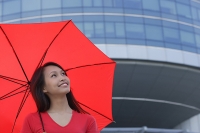 Woman with red umbrella, looking up - Asia Images Group