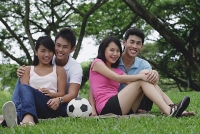 Young adults in park, smiling at camera - Asia Images Group