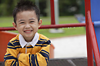 Young boy in striped shirt, smiling at camera - Asia Images Group