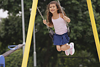 Girl on playground swing - Asia Images Group