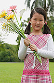Girl holding bouquet of flowers - Asia Images Group