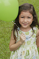 Girl with green balloon, portrait - Asia Images Group
